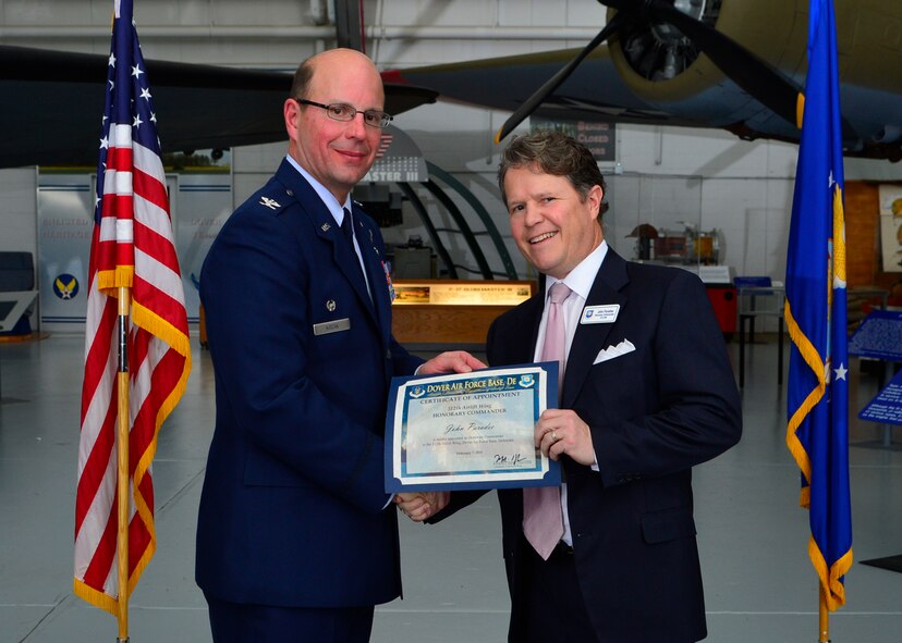 Col. Raymond A. Kozak, 512th Airlift Wing commander, presents a certificate of induction to John Paradee, Baird, Mandalas & Brockstedt partner, as part of the Team Dover Honorary Commander Induction Ceremony Feb. 7, 2015, at the Air Mobility Command Museum. The Honorary Commander Program began in 1992 at Dover Air Force Base, Del.,to foster relationships between civic and military leaders. (U.S. Air Force photo/Airman 1st Class William Johnson)