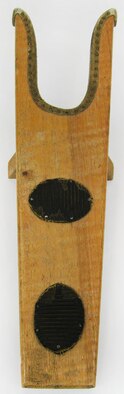 A boot jack is a tool used in the removal of boots. The boot heel is placed in the U-shaped opening of the boot jack, while the other foot is standing on the flat end of the boot jack, and then with a pull the foot is freed from the boot. Boot jacks help prevent stooping and struggling when removing tall riding boots that have been worn all day. And for sanitary purposes, they can keep hands clean of mud and manure while dirty riding boots are being removed. (U.S. Air Force photo)