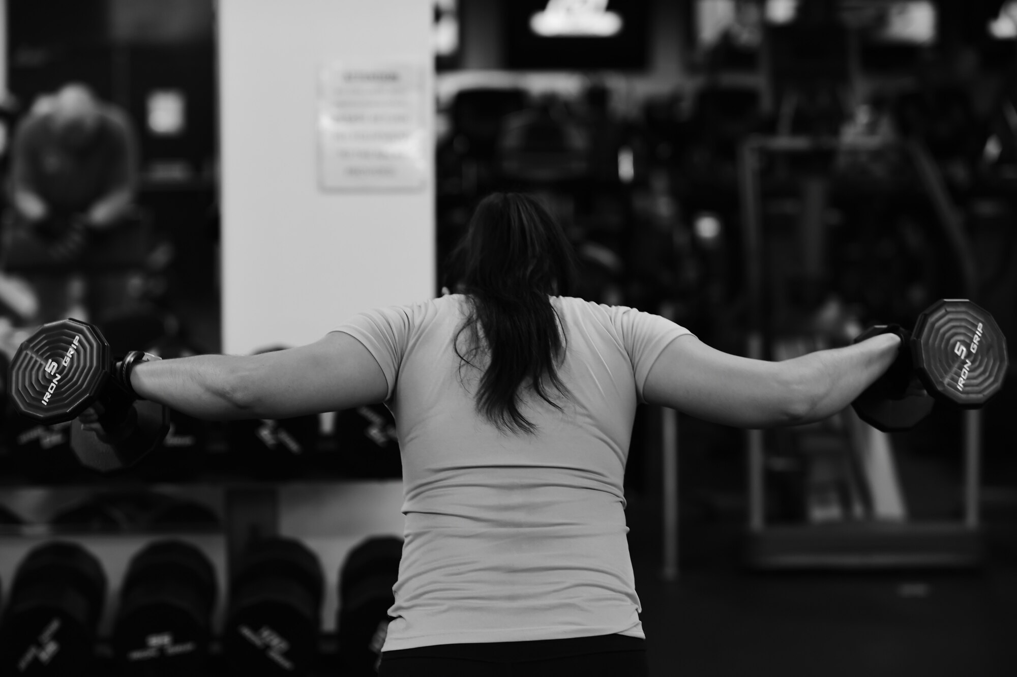 Staff Sgt. Lizeth Rico, 423rd Medical Squadron dental technician, raises a pair of dumbbells during her morning workout at RAF Alconbury, England, Nov. 19, 2014. Rico said her fitness routine gives her more energy, sustained throughout the day. (U.S. Air Force photo by Staff Sgt. Jarad A. Denton/Released)