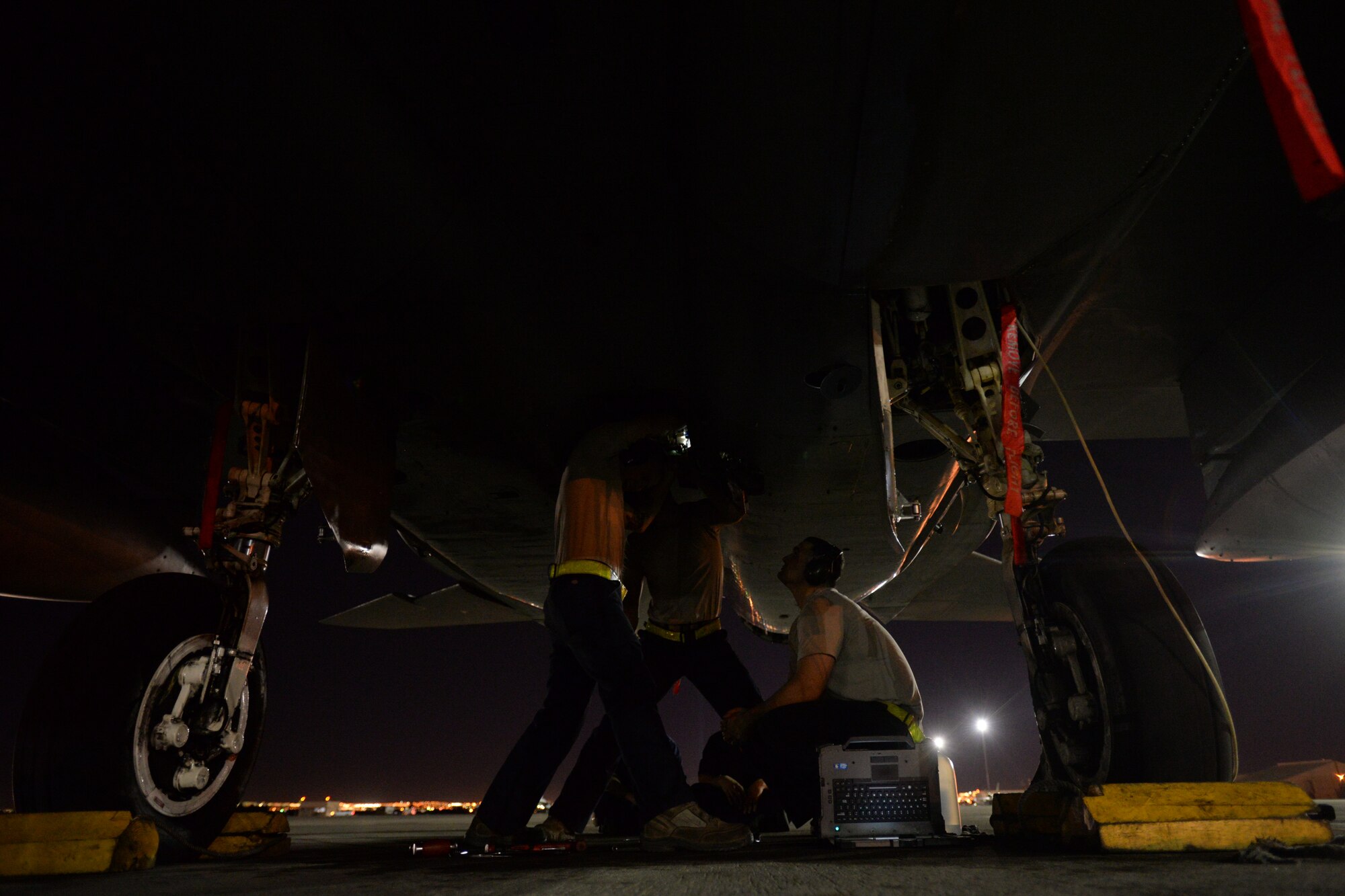 Three maintainers assigned to the 748th Aircraft Maintenance Squadron, Royal Air Force Lakenheath, England, work on an F-15C Eagle during Red Flag 15-1 at Nellis Air Force Base, Nev., Feb. 9, 2015. Flying units from around the world come to Nellis AFB to participate in Red Flag exercises, which are held three to four times per year. (U.S. Air Force photo by Tech. Sgt. Eric Burks/Released)