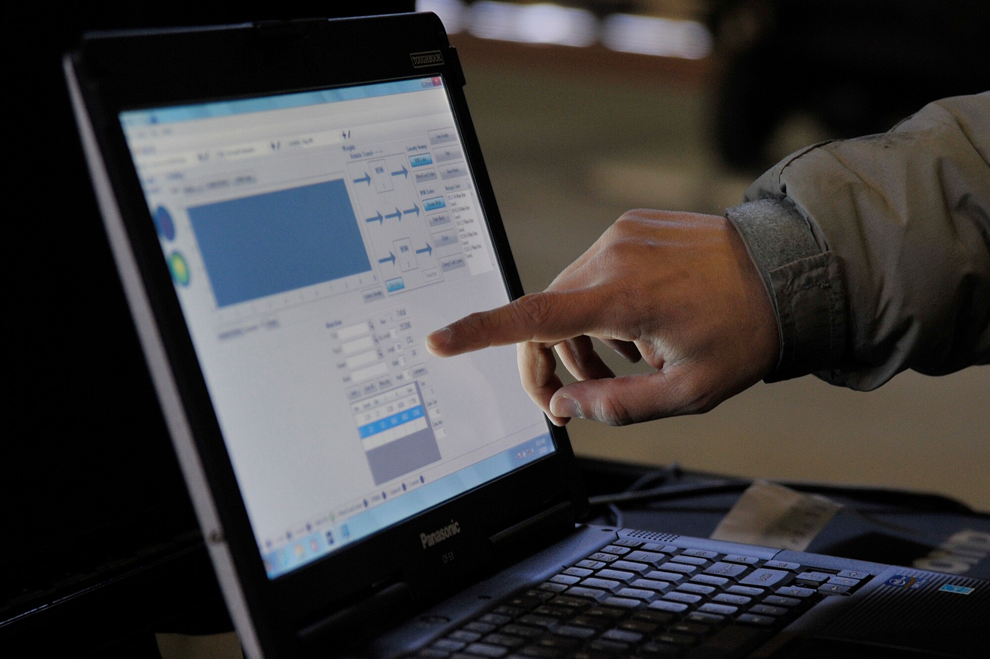 U.S. Air Force Tech. Sgt. Derek Kahaunaele, 35th Logistics Readiness Squadron cargo movement specialist, checks the weight of equipment on the Weigh In Motion system computer software at Misawa Air Base, Japan, Feb. 9, 2015. The newly acquired WIM system has the potential of pushing cargo through the check-in processing line twice as fast as the previous floor scale system. (U.S. Air Force photo by Senior Airman Jose L. Hernandez-Domitilo)
