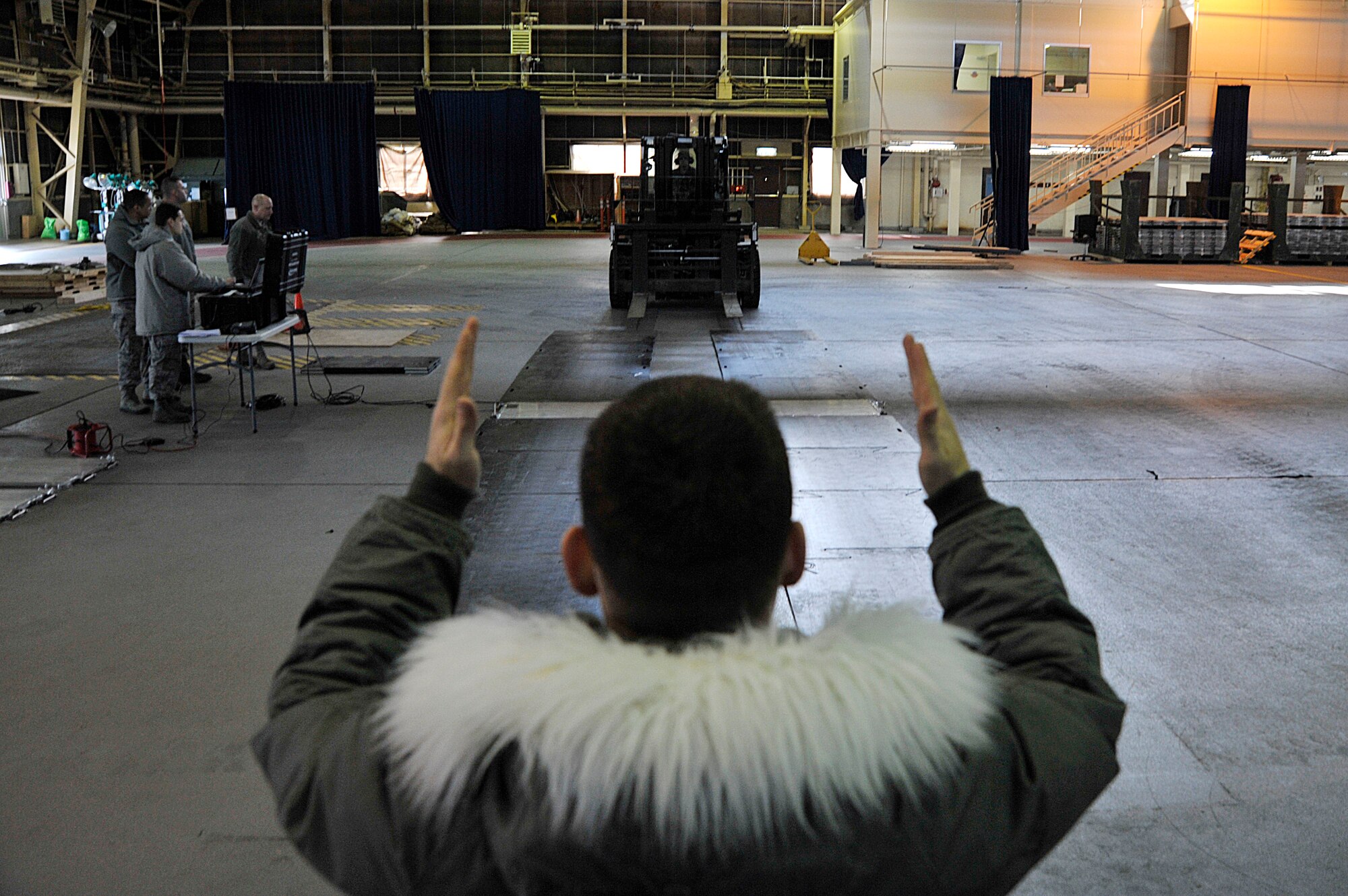 U.S. Air Force Senior Airman Eric Raber, 35th Logistics Readiness Squadron cargo movement specialist, guides a forklift onto a portable Weigh In Motion system platform at Misawa Air Base, Japan, Feb. 9, 2015. The 35 LRS recently acquired a new portable Weigh In Motion system to help streamline cargo movement during deployments and other mobilization efforts by increasing the speed of the check-in process. (U.S. Air Force photo by Senior Airman Jose L. Hernandez-Domitilo)