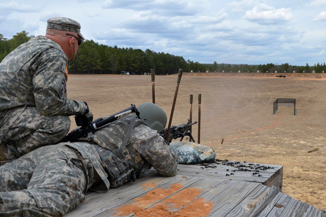 Army Sgt. Seth Crosby, right, fires an M249 Squad Automatic Weapon ...