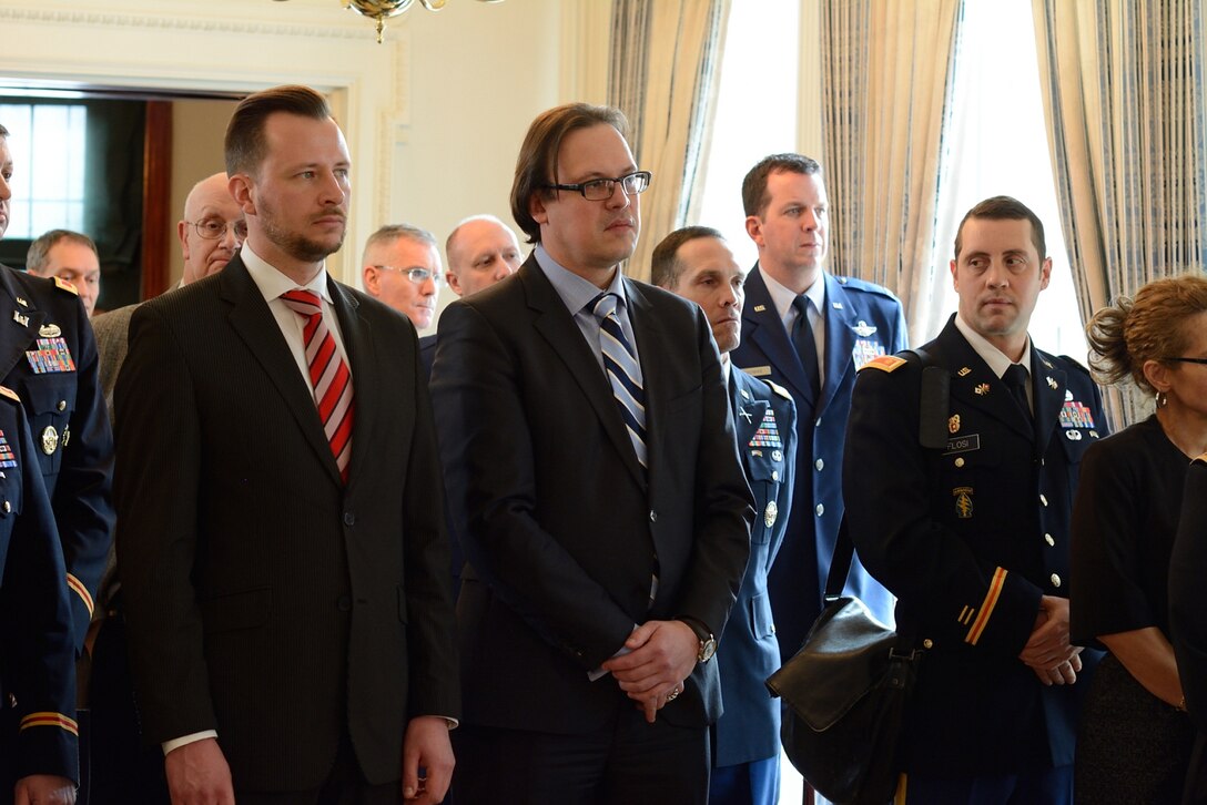 Estonian Ambassador Eerik Marmei, center, and other officials and guests listen as Acting Assistant Defense Secretary for Reserve Affairs Richard O. Wightman Jr. discusses the details of an official agreement at the Estonian Embassy in Washington, D.C., Feb. 10, 2015.