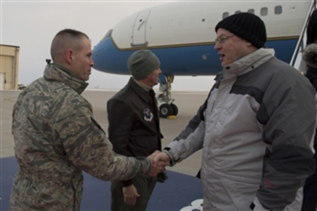 Air Force Col. Michael Lutton, commander, 91st Missile Wing, welcomes Deputy Defense Secretary Bob Work as he arrives at Minot Air Force Base, N.D., Feb. 10, 2015. Work, who is chair of the Nuclear Deterrent Enterprise Review Group, is there to meet with nuclear enterprise airmen and tour the facilities. 
