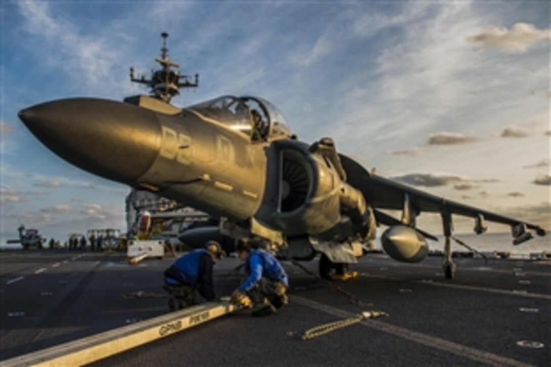 U.S. Navy sailors prepare to move an AV-8B Harrier on the flight deck of the amphibious assault ship USS Bonhomme Richard in the East China Sea, Feb. 11, 2015. The ship is currently conducting operations in the U.S. 7th Fleet area of responsibility. The sailors are assigned to Marine Attack Squadron 231.