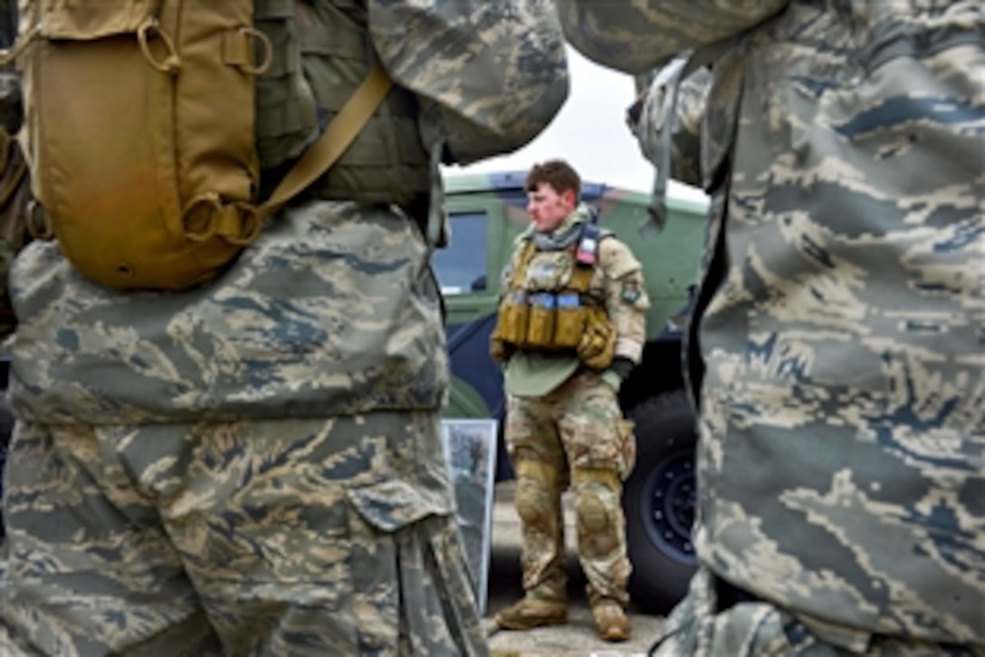 Air Force Staff Sgt. Samuel Weaver, center, gives a mission briefing during Exercise Scorpion Lens 2015 on North Auxiliary Air Field near North, S.C., Feb. 10 , 2015. Weaver is a maintenance technician assigned to the 1st Combat Camera Squadron.
