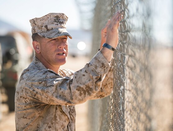 Gunnery Sgt. Kevin D. Pirtle stands against a fence talking to Marines on the other side Feb. 8 at Marine Air Ground Combat Center Twentynine Palms during Integrated Training Exercise 2-15. Pirtle is preparing Headquarters and Service Company to move to the field for the Battalion Assault Course. Pirtle, a Somerville, Tennessee, native, is an infantry unit leader and the company gunnery sergeant for Headquarters and Service Company, 2nd Battalion, 3rd Marine Regiment, 3rd Marine Division, III Marine Expeditionary Force. 