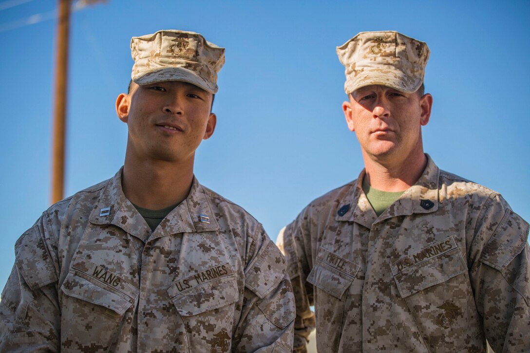 Gunnery Sgt. Kevin D. Pirtle (right) and Capt. Jim C. Wang pose for a photo Jan. 8 at Marine Air Ground Combat Center Twentynine Palms during Integrated Training Exercsie 2-15. Pirtle and Wang spend a lot of time working together in Headquarters and Service Company. Pirtle, a Somerville, Tennessee, native, is an infantry unit leader and the company gunnery sergeant, and Wang, a Fayetteville, North Carolina native, is an infantry officer and company commander, both with Headquarters and Service Company, 2nd Battalion, 3rd Marine Regiment, 3rd Marine Division, III Marine Expeditionary Force. 