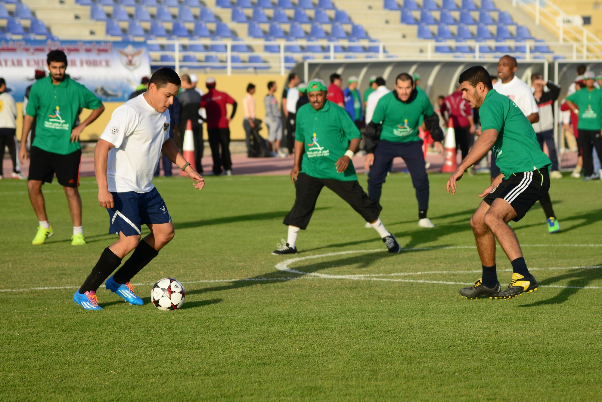 U.S. servicemembers and Qatar Emiri Air Force members play a friendly game of soccer during Qatar National Sports Day, Feb. 10, 2015, at Al Udeid Air Base, Qatar. National Sports Day is a national holiday in Qatar, held annually since 2011 on the second Tuesday of February with the main objective being to promote a healthy lifestyle. (U.S. Air Force photo by Senior Airman Kia Atkins)
