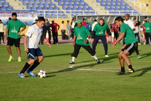 U.S. servicemembers and Qatar Emiri Air Force members play a friendly game of soccer during Qatar National Sports Day, Feb. 10, 2015, at Al Udeid Air Base, Qatar. National Sports Day is a national holiday in Qatar, held annually since 2011 on the second Tuesday of February with the main objective being to promote a healthy lifestyle. (U.S. Air Force photo by Senior Airman Kia Atkins)