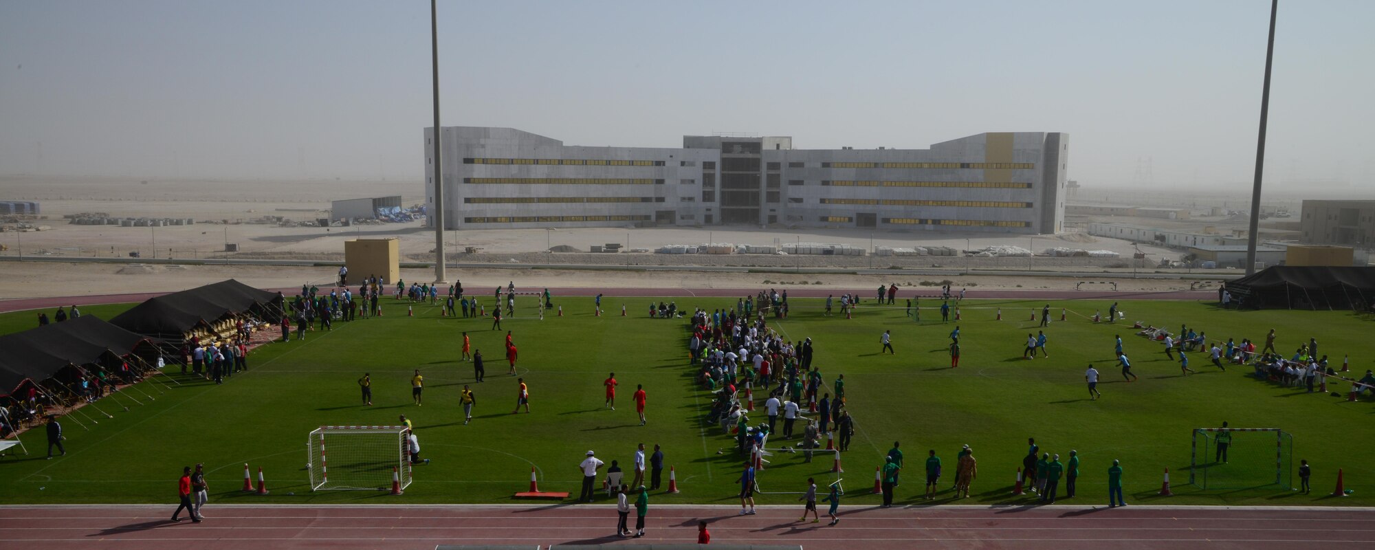 U.S. servicemembers and Qatar Emiri Air Force members play various sports during Qatar National Sports Day, Feb. 10, 2015, at Al Udeid Air Base, Qatar. More than 80 servicemembers teamed up to form basketball, soccer and volleyball teams to compete with the Qatar Emiri Air Force during their sports day. (U.S. Air Force photo by Senior Airman Kia Atkins)