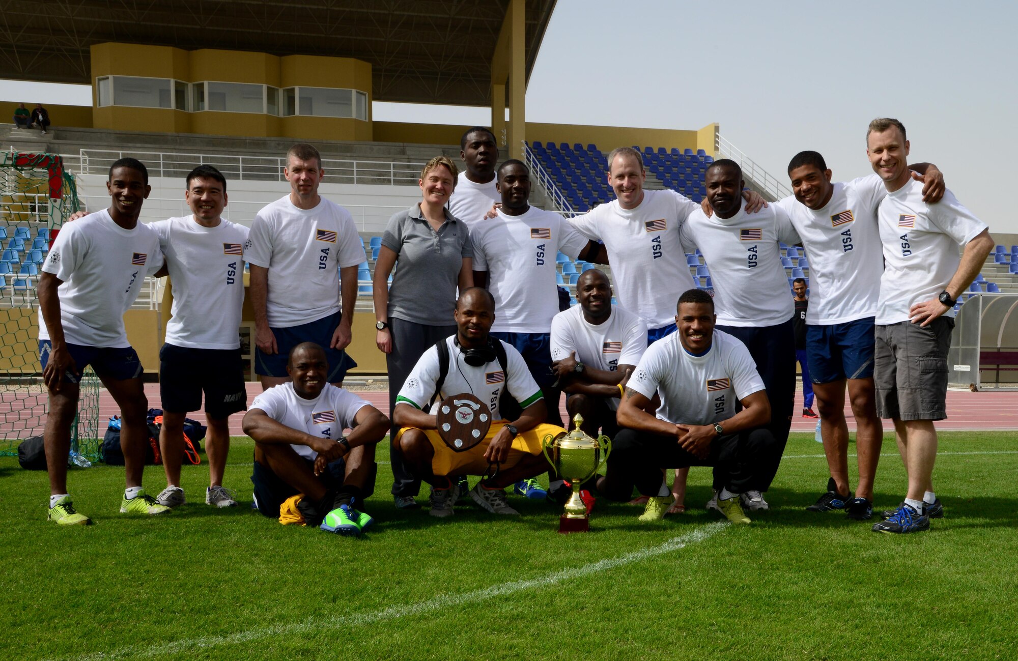U.S. servicemembers, who participated in Qatar National Sports Day, gathered for a team photo after competing in a soccer game, Feb. 10, 2015, at Al Udeid Air Base, Qatar. The Qatar National Sports Day is an initiative adopted in 2011 by the current Emir, Sheikh Tamim bin Hamad Al Thani, to further embed sporting values into the nation's culture and inspire people to be healthy and engage in physical activities. (U.S. Air Force photo by Senior Airman Kia Atkins)