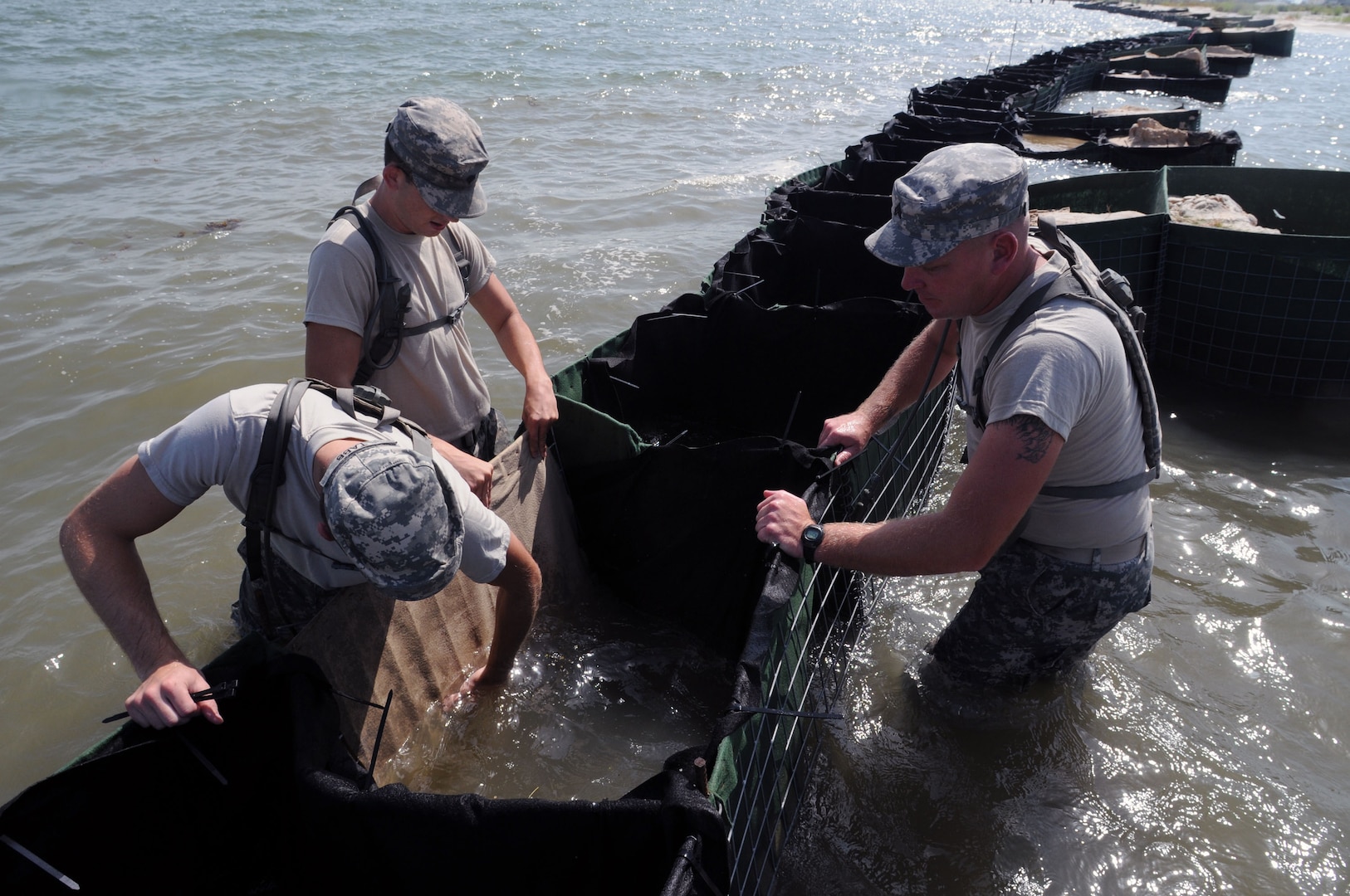 Soldiers from the Alabama National Guard build and maintain miles of HESCO barriers to protect Dauphin Island, Ala., beaches from the BP oil spill, July 23, 2010. More than 1,600 National Guard members  supported Operation Deepwater Horizon in four Gulf states.