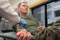 Staff Sgt. Brandon Winn, a recruiter with Recruiting Substation North Lansing, Recruiting Station Lansing, 9th Marine Corps District, gives blood during an annual blood drive hosted by RS Lansing Feb. 9. The Marines donated enough blood to potentially save the lives of 69 people. 