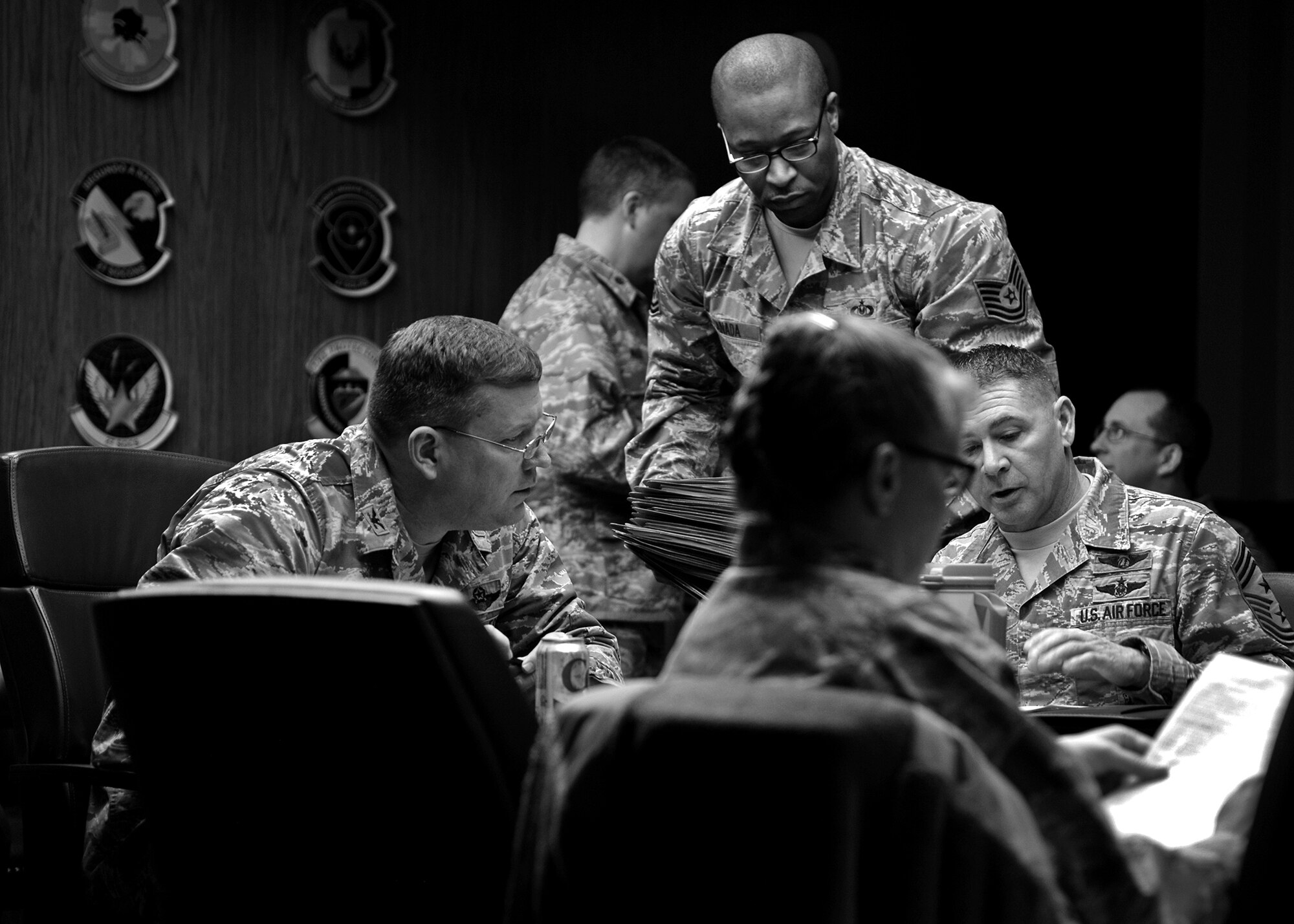 U.S. Air Force Col. Tony D. Bauernfeind, 27th Special Operations Wing commander, speaks with Chief Master Sgt. Randy Scanlan, 27th SOW command chief, during officer and senior noncommissioned officer performance reviews Jan. 21, 2015 at Cannon Air Force Base, N.M. Leaders gathered with the intent of leveraging their collective experience to help develop the team’s top-performing officers and SNCOs, and to discuss those who had made the hard choice to enter the civilian sector. (U.S. Air Force photo/Airman 1st Class Chip Slack)