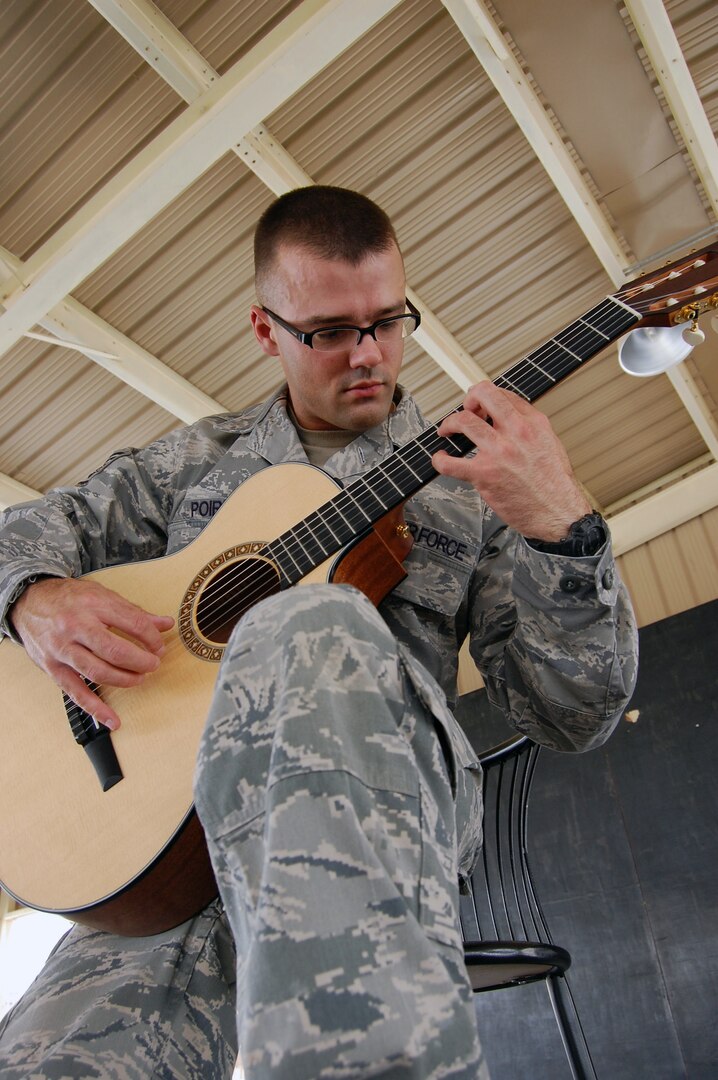 Air Force Staff Sgt. Israel Poire of the Oklahoma Air National Guard practices on his guitar at an air base in Southwest Asia May 28, 2010.