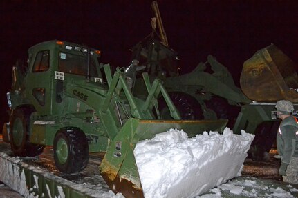 Massachusetts Army Soldiers from the 379th Engineer Company, 101st Engineer Battalion, arrive Feb. 10, 2015, to stage their equipment in Hull, which was pounded by heavy snow.
