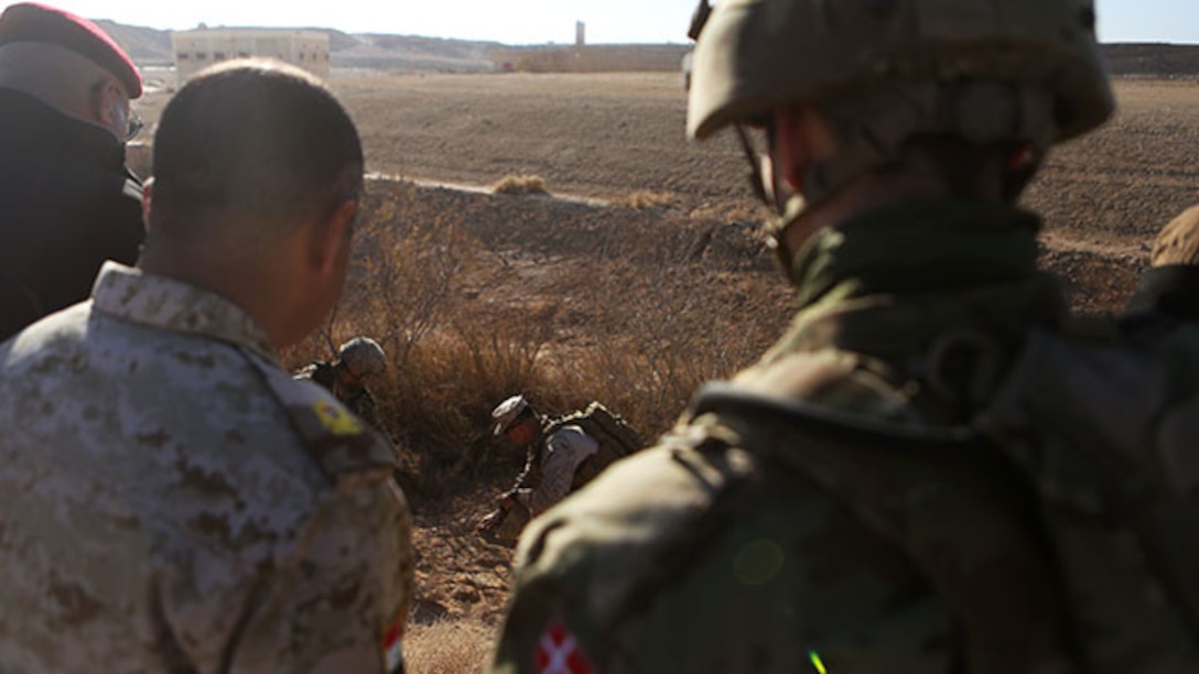 U.S. Marine Chief Warrant Officer 2 Juan Rodriguez, an explosive ordnance disposal officer, a Danish soldier, both assigned to Task Force Al Asad, and brigade-level leaders of the Iraqi Army walk through an improvised explosive device training lane aboard Al Asad Air Base, Iraq, Jan. 31, 2015. The classes showed the leadership the training their soldiers will receive in the future and gave them a look at tactics being used today by Da'esh.