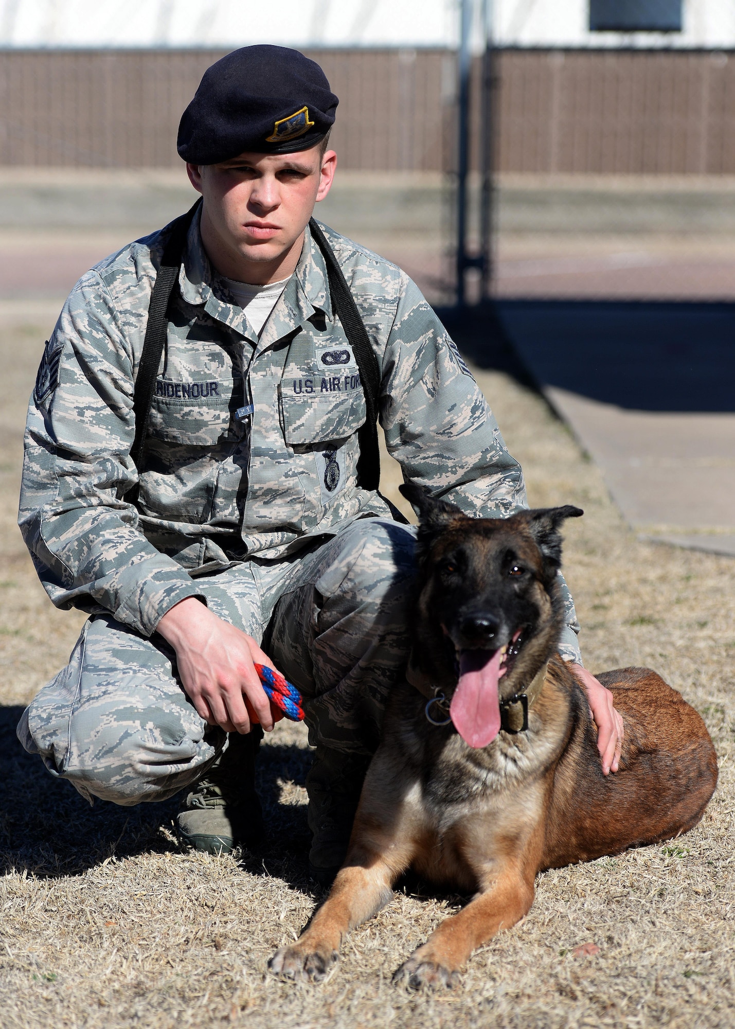 U.S. Air Force Staff Sgt. Justin Ridenour, 97th Security Forces Squadron military working dog handler, kneels with his working dog, Yyoda, at Altus Air Force Base, Oklahoma, Feb. 10, 2015. Ridenour has been a military working dog handler for four years, and he and Yyoda have been partners since he arrived in Altus in March 2014. (U.S. Air Force photo by Airman 1st Class Megan E. Acs)