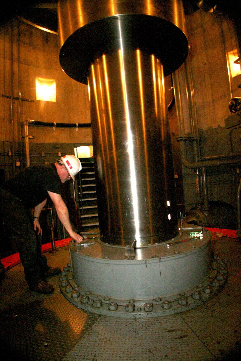 Senior Mechanic Rod Bergin inspects a hydro-electrical generator’s turbine shaft during annual maintenance of the unit at Fort Randall Dam.