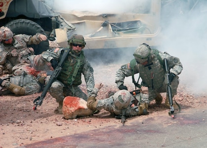 Staff Sgt Amanda Morgan and Michael Thompson, both of the 1344th Transportation Company of the Illinois National Guard, participate in an urban warfare training exercise at Fort Irwin, Calif., during the unit's annual training in May. Morgan and Thompson evaluated a casualty and prepared to evacuate the wounded Soldier to a safe location.