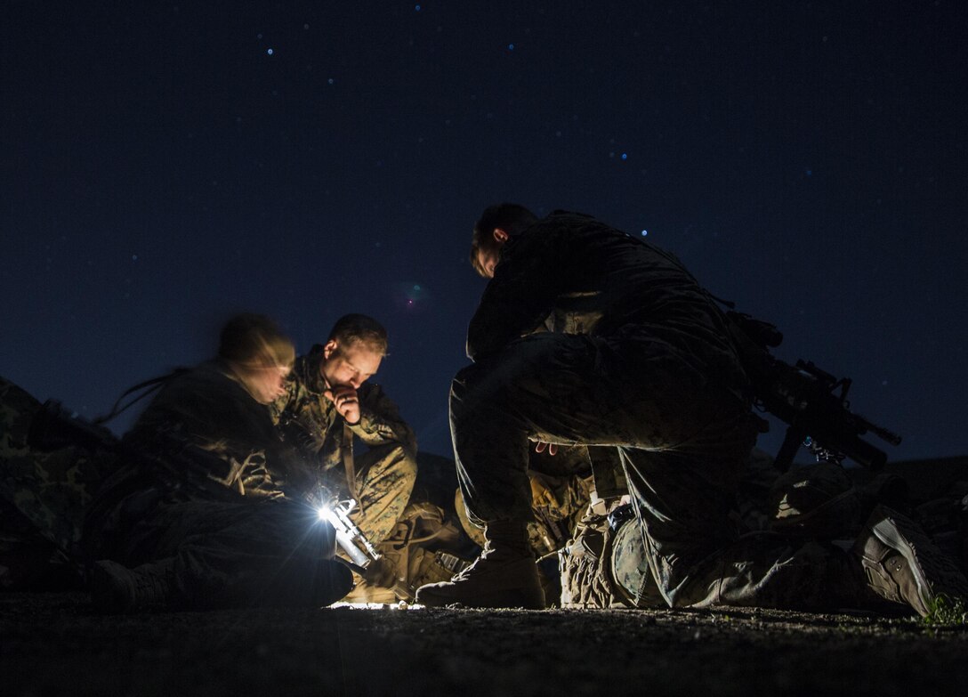 U.S. Marines with Kilo Company, Battalion Landing Team 3rd Battalion, 1st Marine Regiment, 15th Marine Expeditionary Unit, plan a mission during squad tactics and maneuver training aboard Camp Pendleton, Calif., Jan. 27, 2015. As the ground combat element for the 15th MEU, BLT 3/1 is preparing for their upcoming deployment by enhancing their combat skills and learning to work as a cohesive unit. (U.S. Marine Corps Photo by Sgt. Emmanuel Ramos/Released)