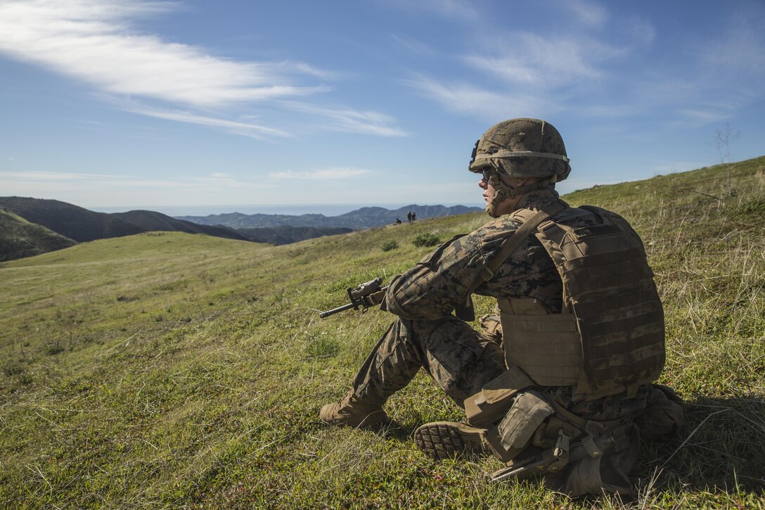 U.S. Marine Pfc. Jacob Westbrook provides security during squad tactics and maneuver training exercise aboard Camp Pendleton, Calif., Jan. 27, 2015. Pfc. Westbrook is a rifleman with Kilo Company, Battalion Landing Team 3rd Battalion, 1st Marine Regiment, 15th Marine Expeditionary Unit. As the ground combat element for the 15th MEU, BLT 3/1 is preparing for their upcoming deployment by enhancing their combat skills and learning to work as a cohesive unit. (U.S. Marine Corps Photo by Sgt. Emmanuel Ramos/Released)
