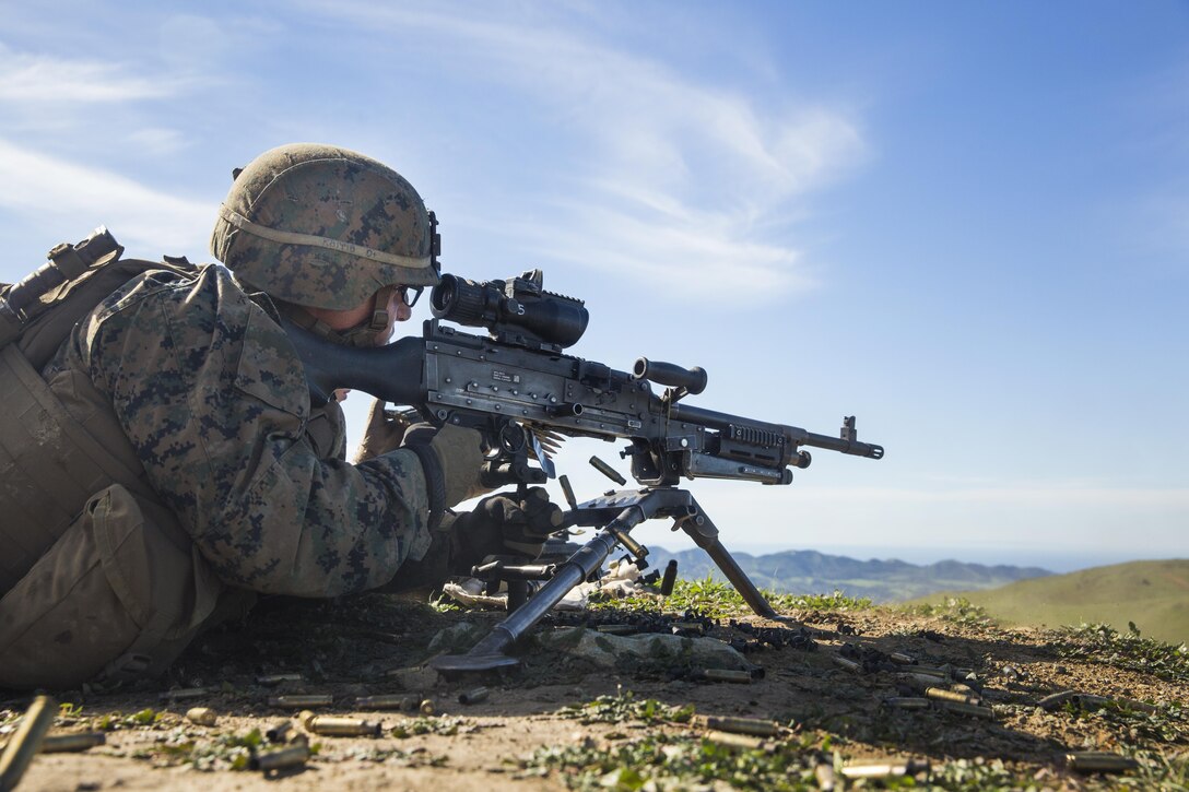 U.S. Marine Lance Cpl. Alexander Basco engages targets with his M240B machine gun during squad tactics and maneuver training aboard Camp Pendleton, Calif., Jan. 27, 2015. Bosco is a rifleman with Kilo Company, Battalion Landing Team 3rd Battalion, 1st Marine Regiment, 15th Marine Expeditionary Unit. As the ground combat element for the 15th MEU, BLT 3/1 is preparing for their upcoming deployment by enhancing their combat skills and learning to work as a cohesive unit. (U.S. Marine Corps Photo by Sgt. Emmanuel Ramos/Released)