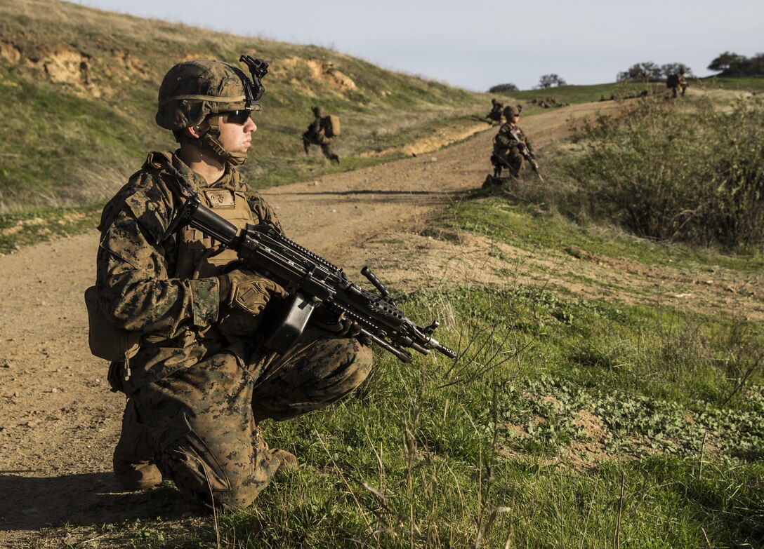 U.S. Marine Lance Cpl. Brandon Swindell provides security during squad tactics and maneuver training aboard Camp Pendleton, Calif., Jan. 28, 2015. Swindell is an automatic rifleman with Kilo Company, Battalion Landing Team 3rd Battalion, 1st Marine Regiment, 15th Marine Expeditionary Unit. As the ground combat element for the 15th MEU, BLT 3/1 is preparing for their upcoming deployment by enhancing their combat skills and learning to work as a cohesive unit. (U.S. Marine Corps Photo by Sgt. Emmanuel Ramos/Released)