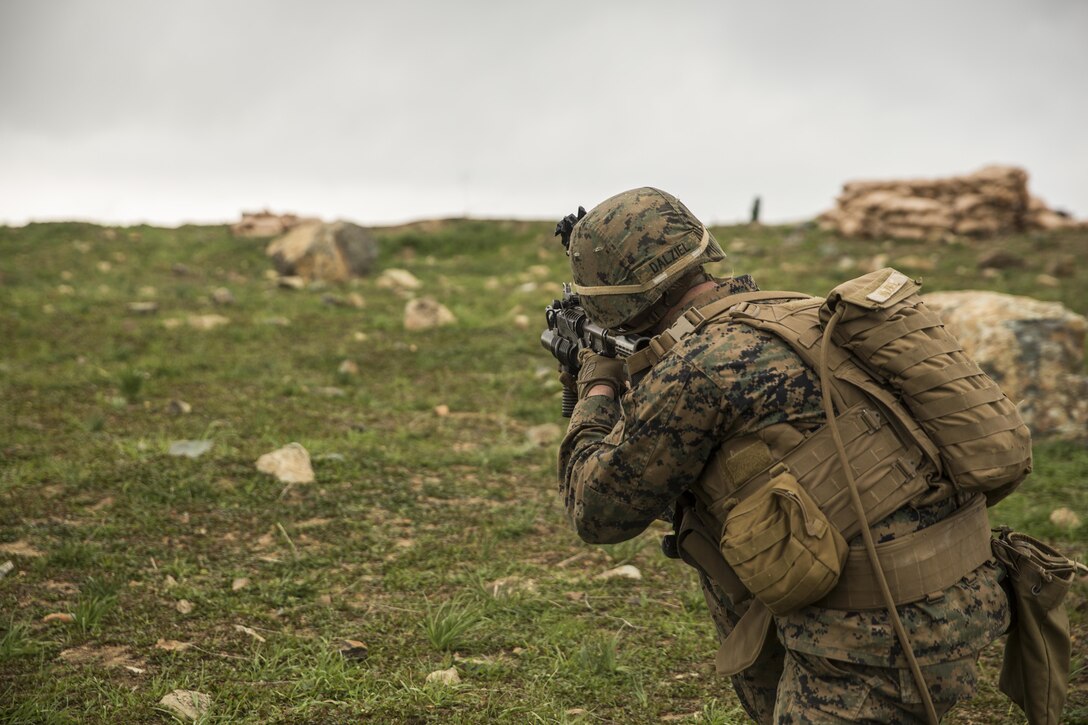 U.S. Marine Lance Cpl. Alexander Dalziel engages targets during squad tactics and maneuver training aboard Camp Pendleton, Calif., Jan. 29, 2015. Daziel is a team leader with Kilo Company, Battalion Landing Team 3rd Battalion, 1st Marine Regiment, 15th Marine Expeditionary Unit. As the ground combat element for the 15th MEU, BLT 3/1 is preparing for their upcoming deployment by enhancing their combat skills and learning to work as a cohesive unit. (U.S. Marine Corps Photo by Sgt. Emmanuel Ramos/Released)