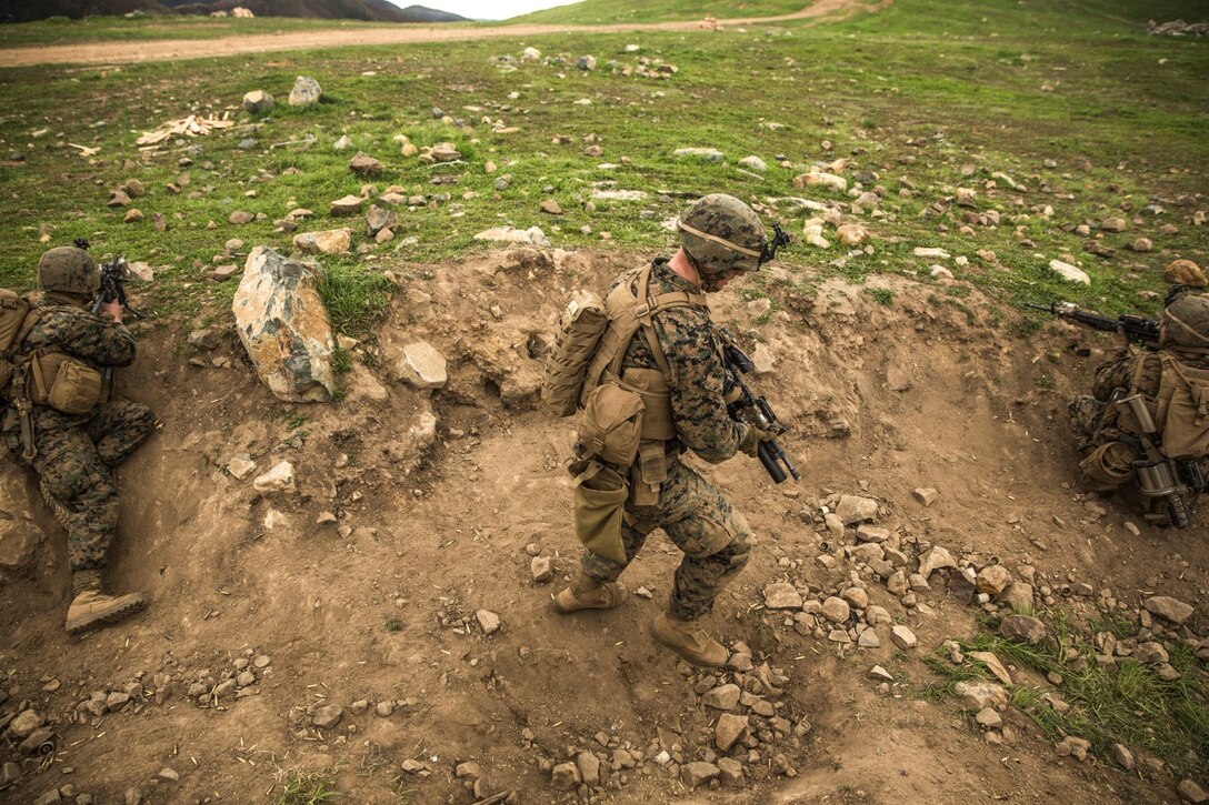 U.S. Marine Lance Cpl.  Alexander Dalziel moves under fire during squad tactics and maneuver training aboard Camp Pendleton, Calif., Jan. 29, 2015. Daziel is a team leader with Kilo Company, Battalion Landing Team 3rd Battalion, 1st Marine Regiment, 15th Marine Expeditionary Unit. As the ground combat element for the 15th MEU, BLT 3/1 is preparing for their upcoming deployment by enhancing their combat skills and learning to work as a cohesive unit. (U.S. Marine Corps Photo by Sgt. Emmanuel Ramos/Released)
