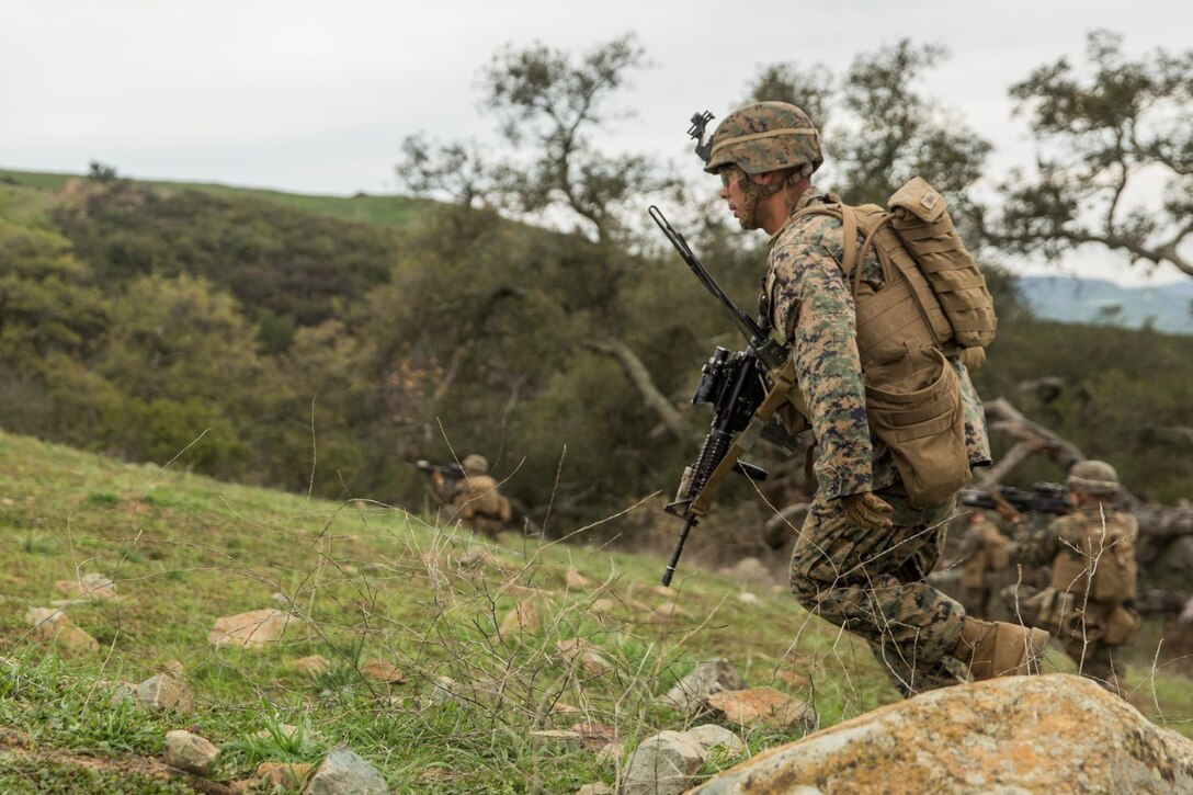 U.S. Marine Sgt. Juan Zamora moves under fire during squad tactics and maneuver training aboard Camp Pendleton, Calif., Jan. 29, 2015. Zamora is a squad leader Kilo Company, Battalion Landing Team 3rd Battalion, 1st Marine Regiment, 15th Marine Expeditionary Unit. As the ground combat element for the 15th MEU, BLT 3/1 is preparing for their upcoming deployment by enhancing their combat skills and learning to work as a cohesive unit. (U.S. Marine Corps Photo by Sgt. Emmanuel Ramos/Released)