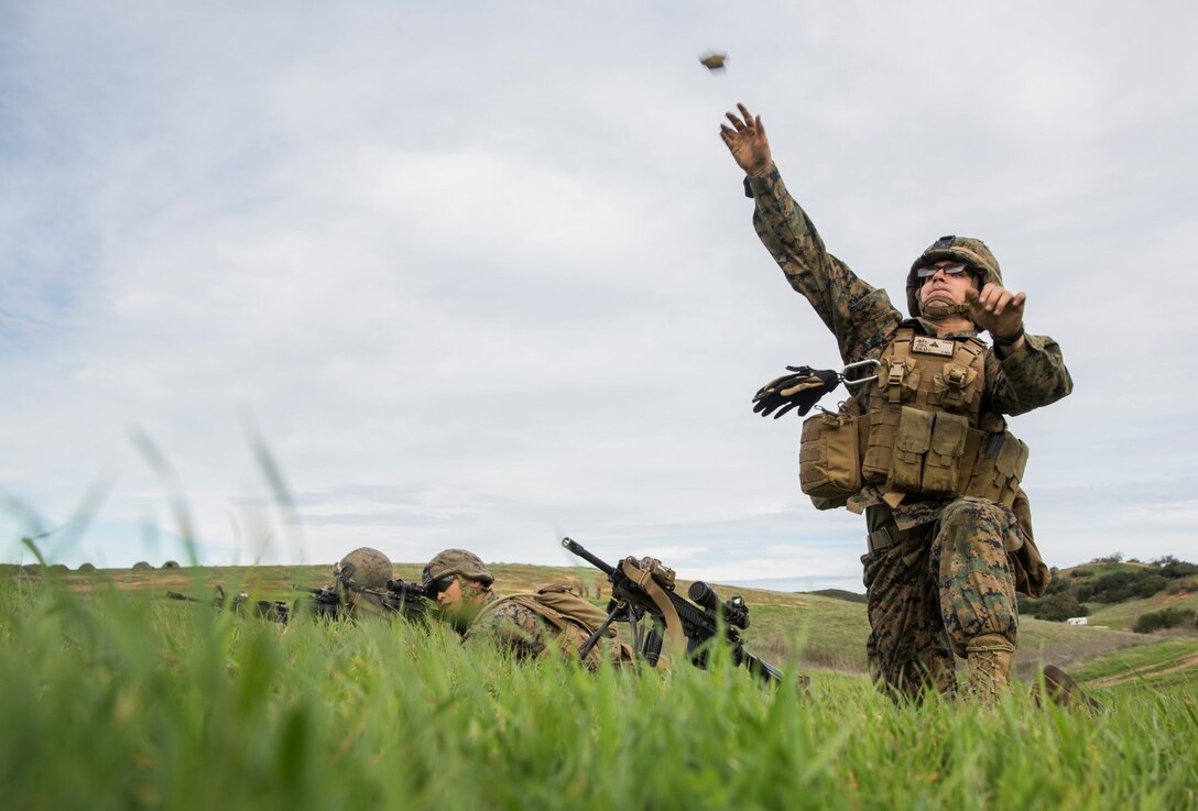 U.S. Marine Pfc. Cody Dunlap throws a simulated grenade during squad tactics and maneuver training aboard Camp Pendleton, Calif., Jan. 26, 2015. Dunlap is an automatic rifleman with Kilo Company, Battalion Landing Team 3rd Battalion, 1st Marine Regiment, 15th Marine Expeditionary Unit. As the ground combat element for the 15th MEU, BLT 3/1 is preparing for their upcoming deployment by enhancing their combat skills and learning to work as a cohesive unit. (U.S. Marine Corps Photo by Sgt. Emmanuel Ramos/Released)