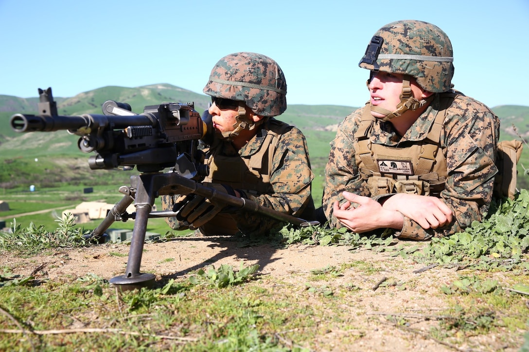 Lance Cpl. Connor J. Shellabarger, a machine gunner for Company K, 3rd Battalion, 5th Marines, 1st Marine Division, listens in along with his junior Marine, on the corrections his instructor has for him during a machine gun course aboard Marine Corps Base Camp Pendleton, Calif., Feb. 4, 2015. Shellabarger is bonding with his junior Marine to create the camaraderie Marines are known for.