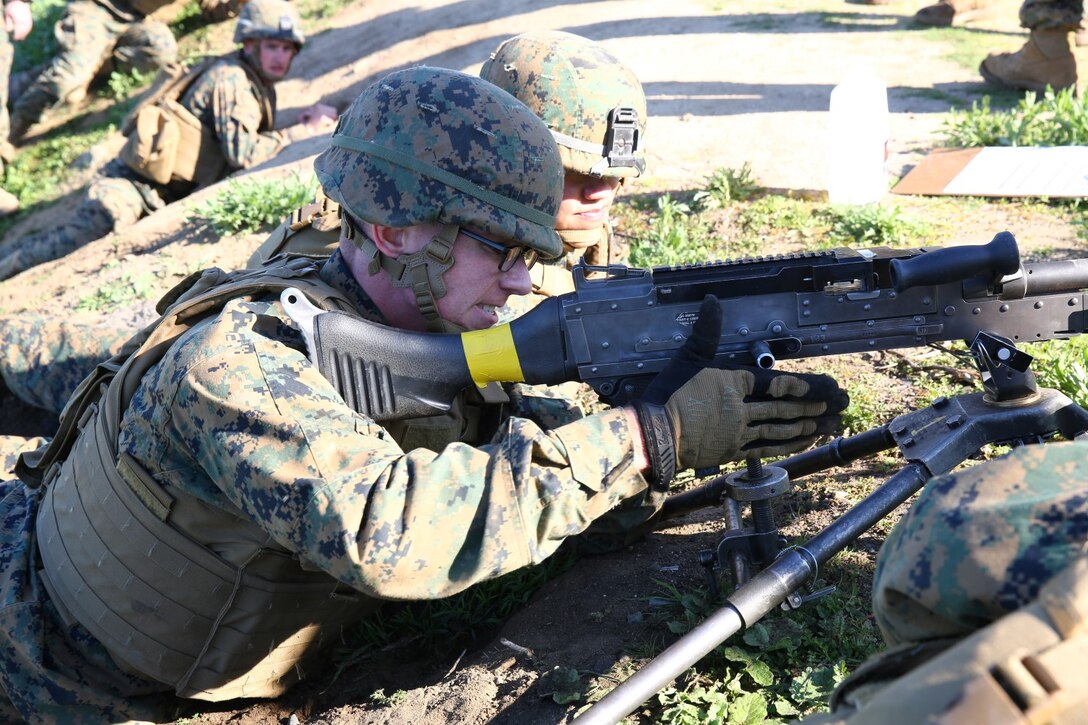 Private First Class Benjamin P. Weathers, a machine gunner for Company K, 3rd Battalion, 5th Marines, 1st Marine Division, and Cpl. Meng Thao, a squad leader for Kilo Company, 3/5, assemble their M240B machine gun during a machine gun course aboard Marine Corps Base Camp Pendleton, Calif., Feb. 4, 2015. Thao demonstrated proper setup procedures to Weathers, testing Weathers’ knowledge of the weapon system after.