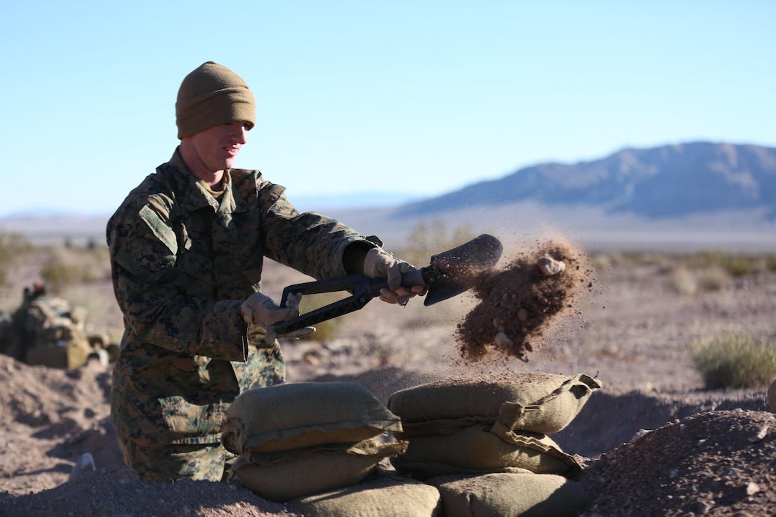 Lance Cpl. Wesley Ammon, Rifleman, Company I, 3rd Battalion, 7th Marine Regiment, a native of Pensacola, Fla., digs a defensive fighting hole during the Marine Corps Combat Readiness Evaluation Exercise aboard the Combat Center, Jan.14, 2015. The Marines of 3/7 participated in the defense while being evaluated by their counterparts from 1st Battalion, 7th Marine Regiment. (Official Marine Corps Photo by Lance Cpl. Julio McGraw/Released)