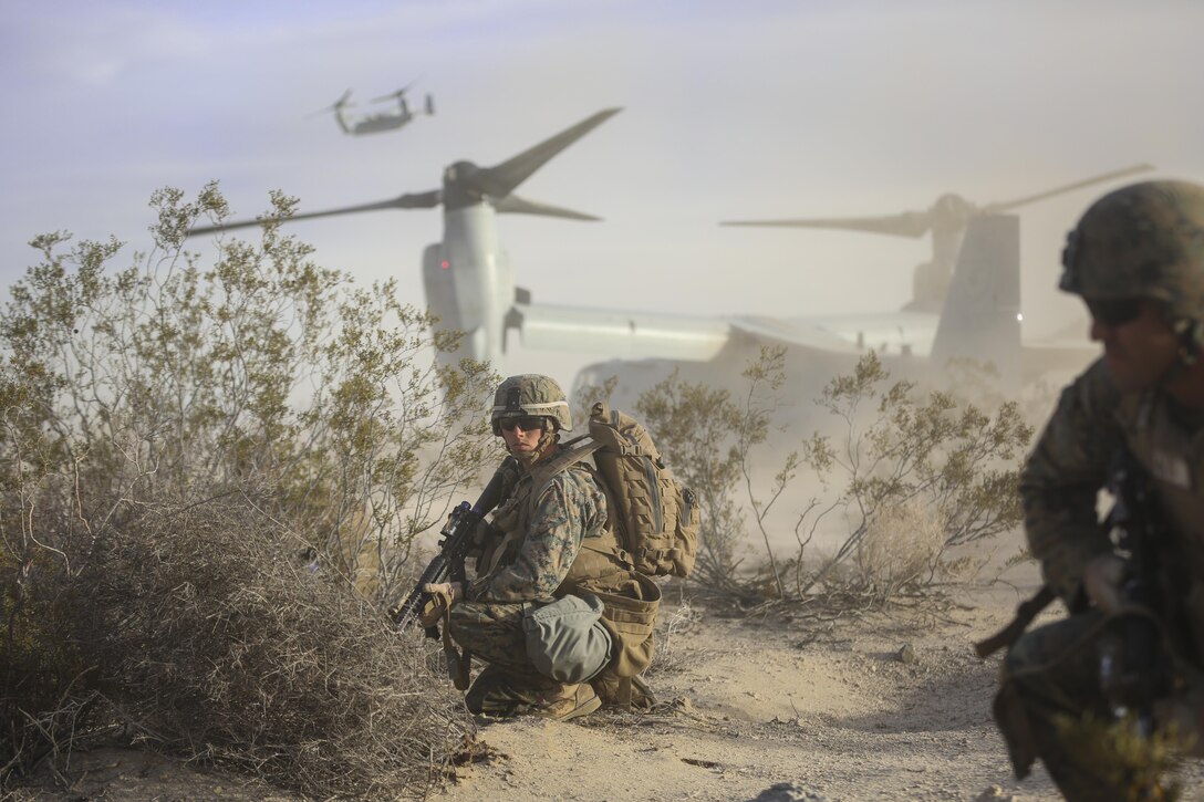 Cpl. Paul Regotti, squad leader, Company I , 3rd Battalion, 7th Marine Regiment, provides security for Marines exiting a MV-22B ‘Osprey’ tilt-rotor aircraft during an air assault on a Military Operation on Urbanized Terrain town during the Marine Corps Combat Readiness Evaluation Exercise, Jan. 16, 2015. (Official Marine Corps Photo by Lance Cpl. Julio McGraw/Released)