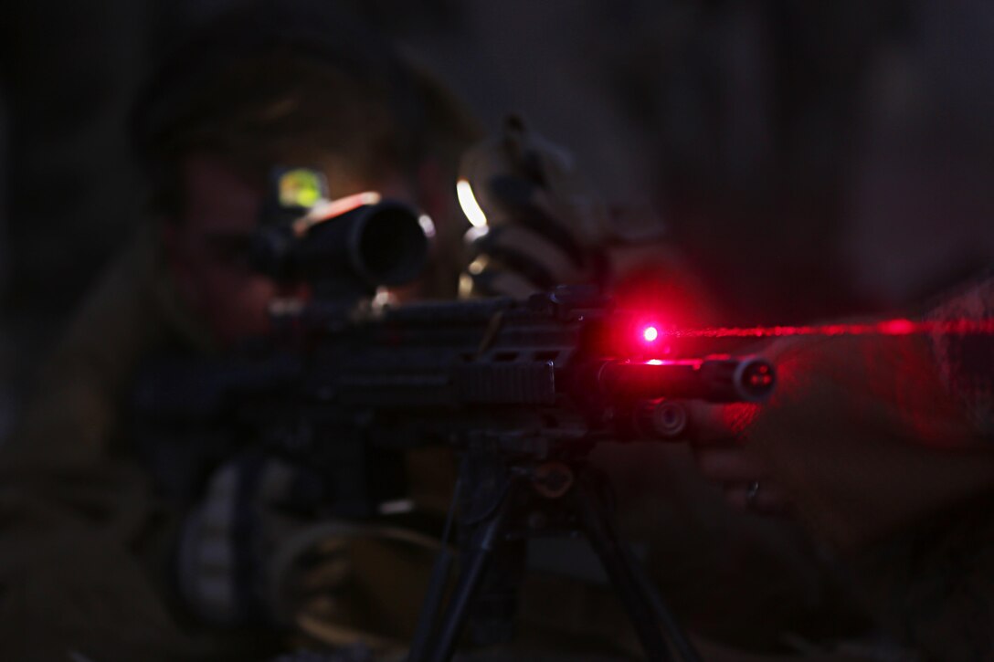 Lance Cpl. Tyler McCabe, rifleman, 3rd Battalion, 7th Marine Regiment, a native of Flowery Branch, Ga., sets up his infrared sight attached to his M27 Infantry Automatic Rifle during a night live-fire exercise at the Morgan’s Well Training area during the Marine Corps Combat Readiness Evaluation Exercise, Jan. 18, 2015. The 10-day exercise tested 3/7’s abilities in defensive positions and offensive objectives. (Official Marine Corps Photo by Lance Cpl. Julio McGraw/Released)