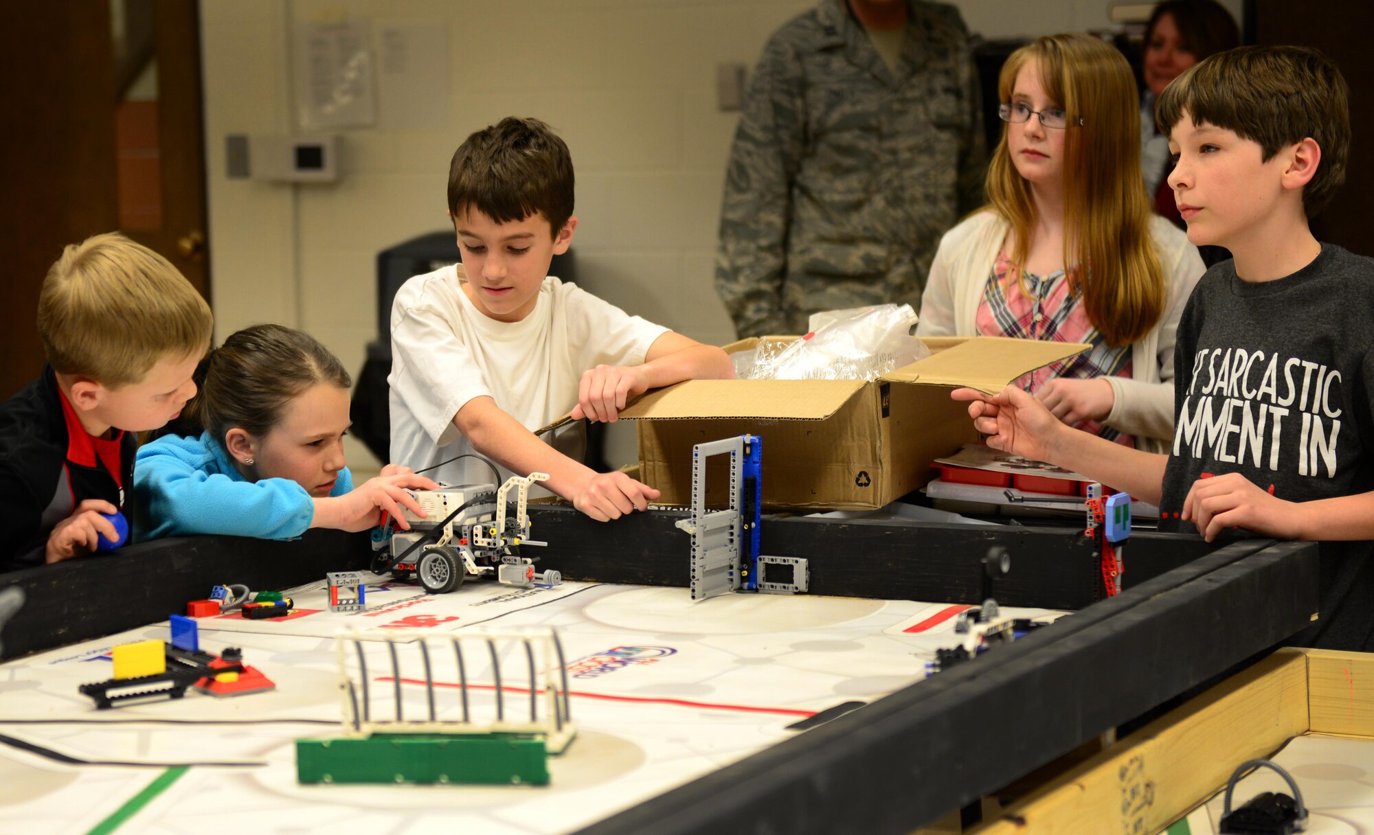 Students from Cannon’s For Inspiration and Recognition of Science and Technology “FIRST” Lego League teams carefully align their robot before running a program Jan. 29, 2015, at Cannon Air Force Base, N.M. Lt. Col. Joyce Storm, 27th Special Operations Mission Support Group deputy commander, and Lori Dunn, 27th Special Operations Force Support Squadron school liaison officer, worked together to bring the league to Cannon in order to offer more challenging activities to students. (U.S. Air Force photo/Airman 1st Class Shelby Kay-Fantozzi)