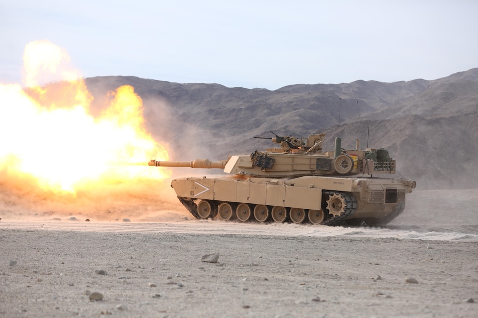 An M1A1 Abrams Tank from 1st Tank Battalion, Company B, fires its 120 mm main gun toward a target 1200 meters away during an assault on a Military Operation in Urban Terrain town on Range 210 during the Marine Corps Combat Readiness Evaluation Exercise, Jan. 20, 2015. ‘1st Tanks’ and 3rd Assault Amphibian Battalion supported 3rd Battalion, 7th Marine Regiment during their assault of the MOUT. (Official Marine Corps Photo by Lance Cpl. Julio McGraw/Released)