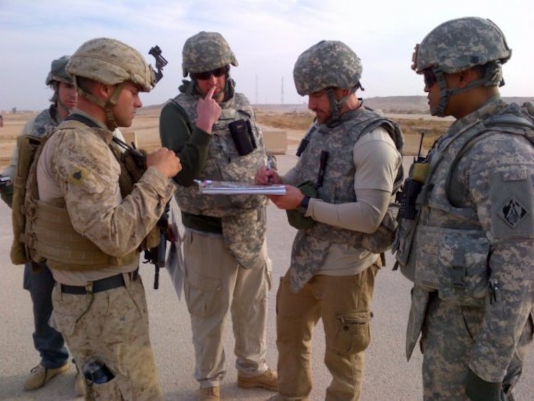 Members of the 62nd Forward Engineer Support Team discuss infrastructure needs with the Marines in Iraq.