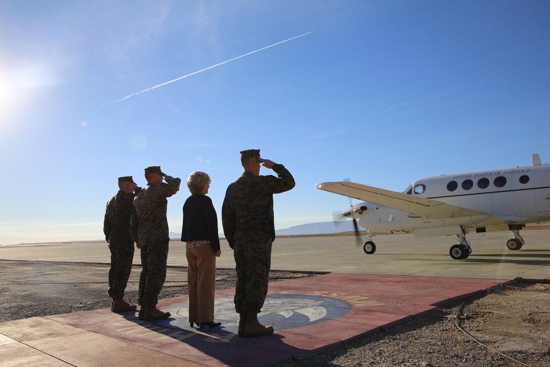 Maj. Gen. Lewis A. Craparotta, commanding general, Marine Corps Air Ground Combat Center, Mrs. Craparotta and the leaders of Marine Wing Support Squadron 374 salute as Lt. Gen. David H. Berger, commanding general, I Marine Expeditionary Force, arrives at the Combat Center’s expeditionary landing field, Feb. 5, 2015. (Official Marine Corps photo by Lance Cpl. Medina Ayala-Lo/Released)