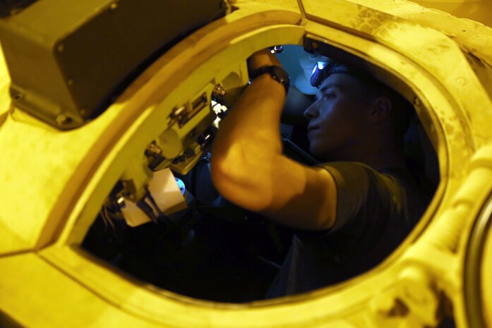 Cpl. Kenneth C. Sobota with the Offload Preparation Party ensures all parts are operational on the Assault Amphibious Vehicles aboard the Maritime Prepositioning Force ship, USNS Pililaau, Feb. 6. The OPP Marines conducted pre-operation checks on all of the vehicles aboard the ship. Their mission is to prepare and offload the equipment from ship to shore for use during Exercise Cobra Gold 2015. Cobra Gold is an annual Thailand /United States, co-sponsored multinational and joint theater security cooperation exercise, conducted in the Kingdom of Thailand. This year 25 nations are participating. Sobota is an AAV repairman with General Support Platoon, and a native of Detroit, Michigan.