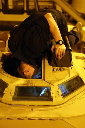 Cpl. Brock W. English with the Offload Preparation Party ensures all parts are operational on the Assault Amphibious Vehicles aboard the Maritime Prepositioning Force ship, USNS Pililaau, Feb. 6. The OPP Marines conducted pre-operation checks on all of the vehicles aboard the ship. Their mission is to prepare and offload the equipment from ship to shore for use during Exercise Cobra Gold 2015. English is an AAV crewman with General Support Platoon, and a Lampasas, Texas, native. 