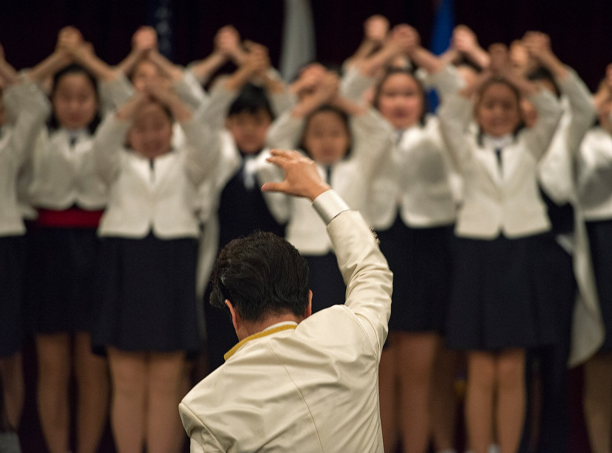 The Far East Broadcasting Company Children's Choir finishes a performance during the National Prayer Breakfast Feb. 12, 2015, at Osan Air Base, Republic of Korea. The intent of the breakfast is to showcase religious diversity and embrace camaraderie. (U.S. Air Force photo by Staff Sgt. Jake Barreiro/Released)