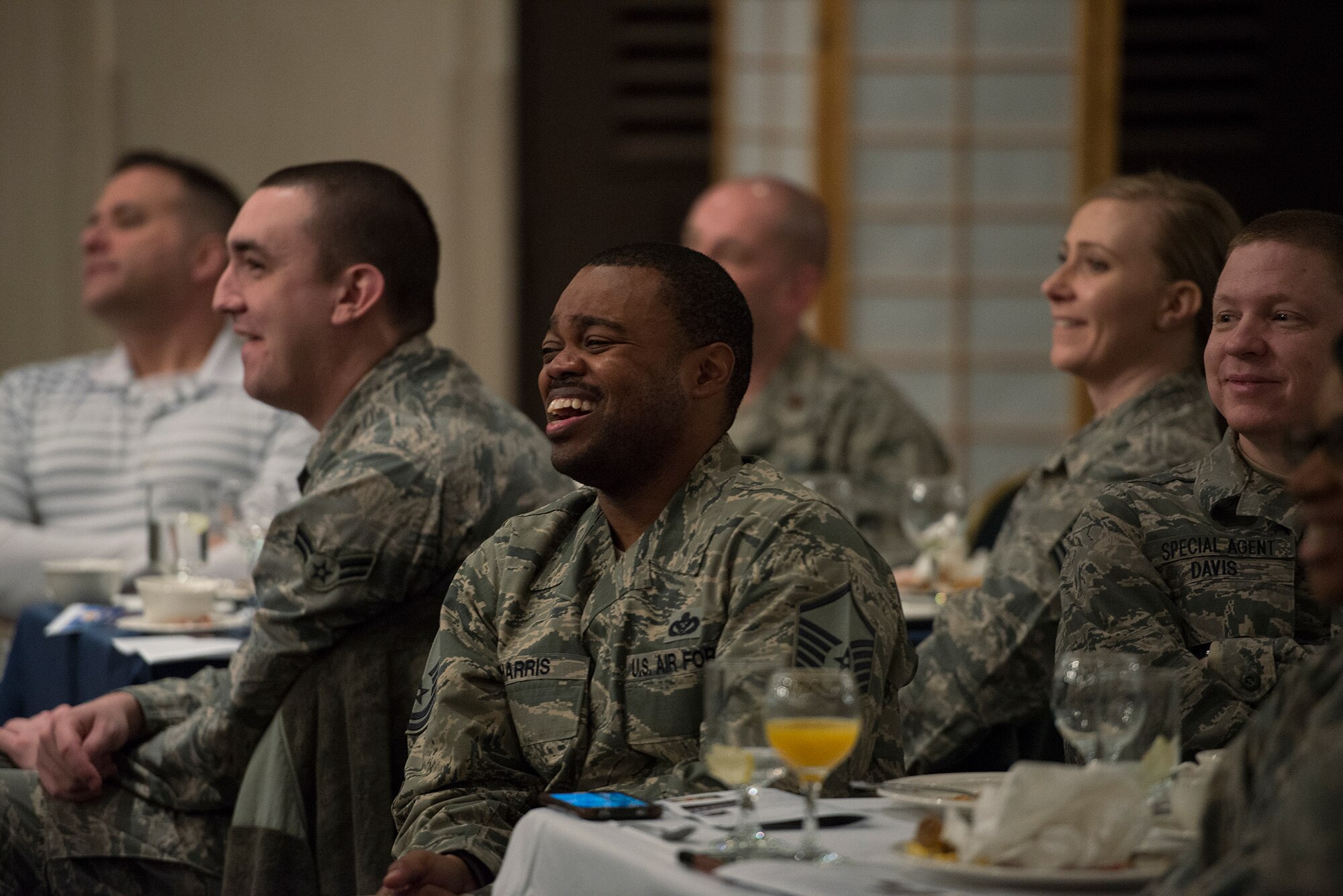 Audience members laugh during an anecdote regaled by Col. Eric Albertonson, United States Forces Korea command chaplain during the National Prayer Breakfast Feb. 12, 2015, at Osan Air Base, Republic of Korea. Albertson was the guest speaker for the event, which was attended by numerous U.S. and ROK team members. (U.S. Air Force photo by Staff Sgt. Jake Barreiro/Released)