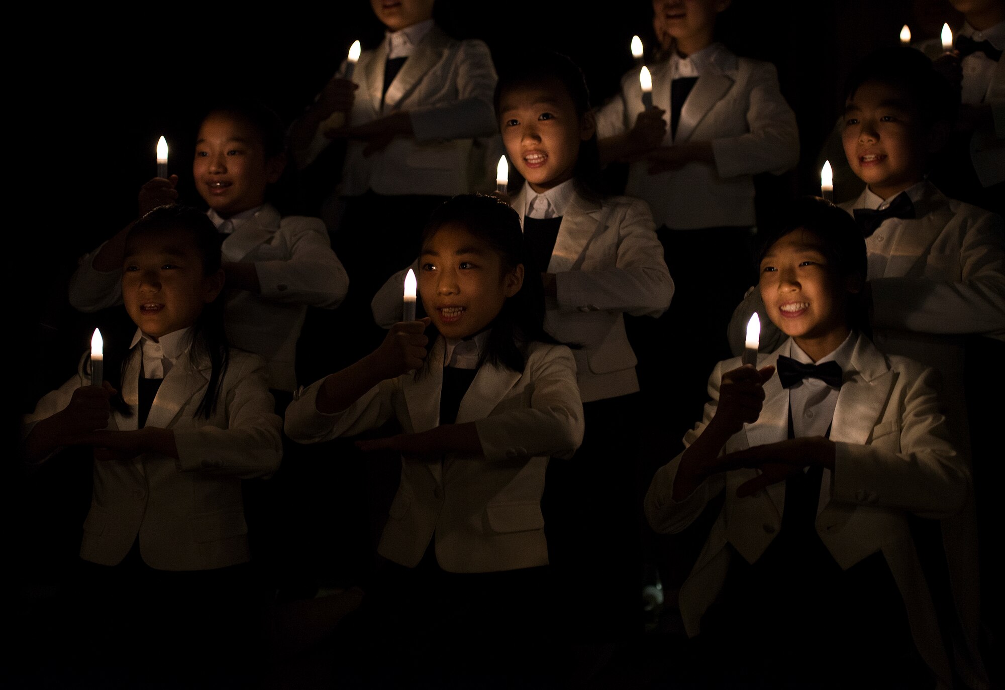 The Far East Broadcasting Company Children's Choir performs a song during the National Prayer Breakfast Feb. 12, 2015, at Osan Air Base, Republic of Korea. The NPB included multiple performances and scripture readings from the Bible and Jewish Liturgy. (U.S. Air Force photo by Staff Sgt. Jake Barreiro/Released)