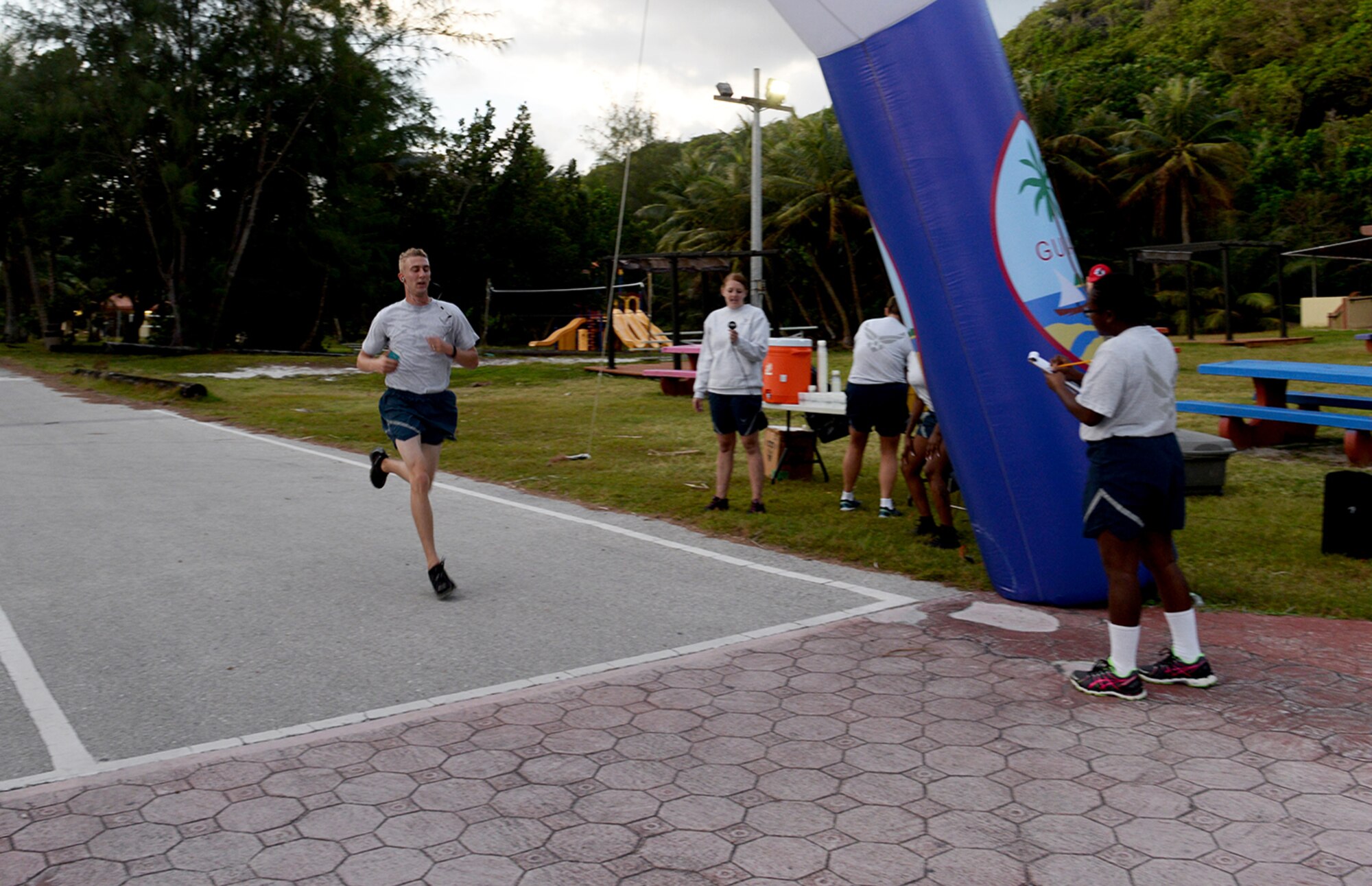 Staff Sgt. Jacob Johnson, 36th Munitions Squadron, passes the finish line during the I Love to Run 5K hosted by the Coral Reef Fitness Center Feb. 11, 2015, at Tarague Beach at Andresen Air Force Base, Guam. Johnson has placed first in five other 5Ks on Andersen (U.S. Air Force photo by Senior Airman Amanda Morris/Released.)