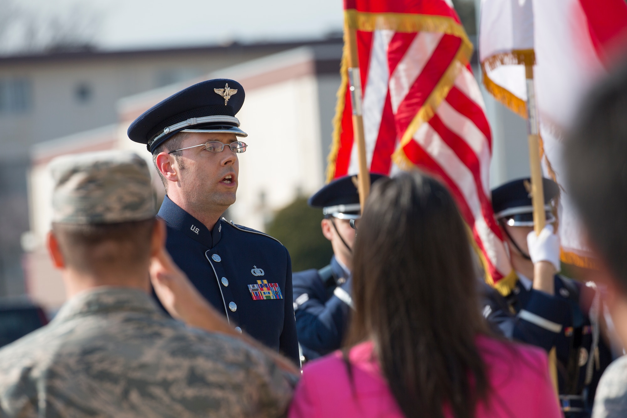 Leaderships from the 374th Airlift Wing salute during the singing of the Japanese and American National Anthem, Feb. 12, 2015, during the cherry tree planting ceremony at Yokota Air Base, Japan. Community leaders from Fussa city donated cherry blossom saplings descended from the cherry trees given to the U.S from Japan in 1912. (U.S. Air Force photo by Osakabe Yasuo/Released)